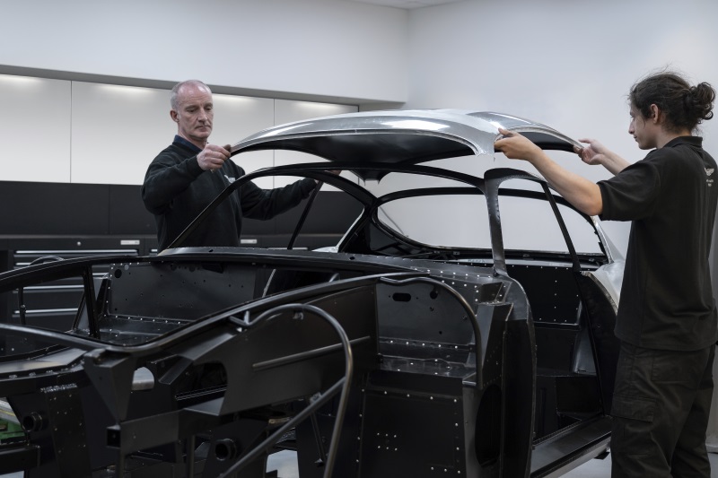 Two men test fitting roof panel on DB4 GT Zagato Continuation