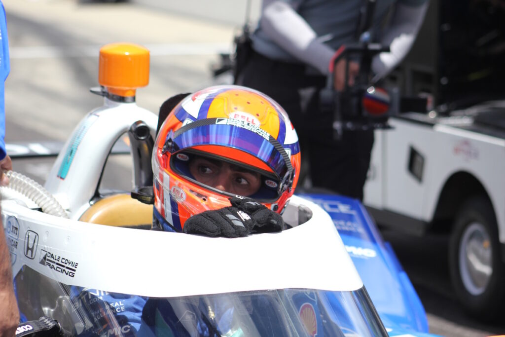 Late on Qualifying Saturday, Rinus VeeKay checks the video screen facing the pit lane before belting in for his run. He qualified last and on race day crashed on lap 81 while entering the pit lane.