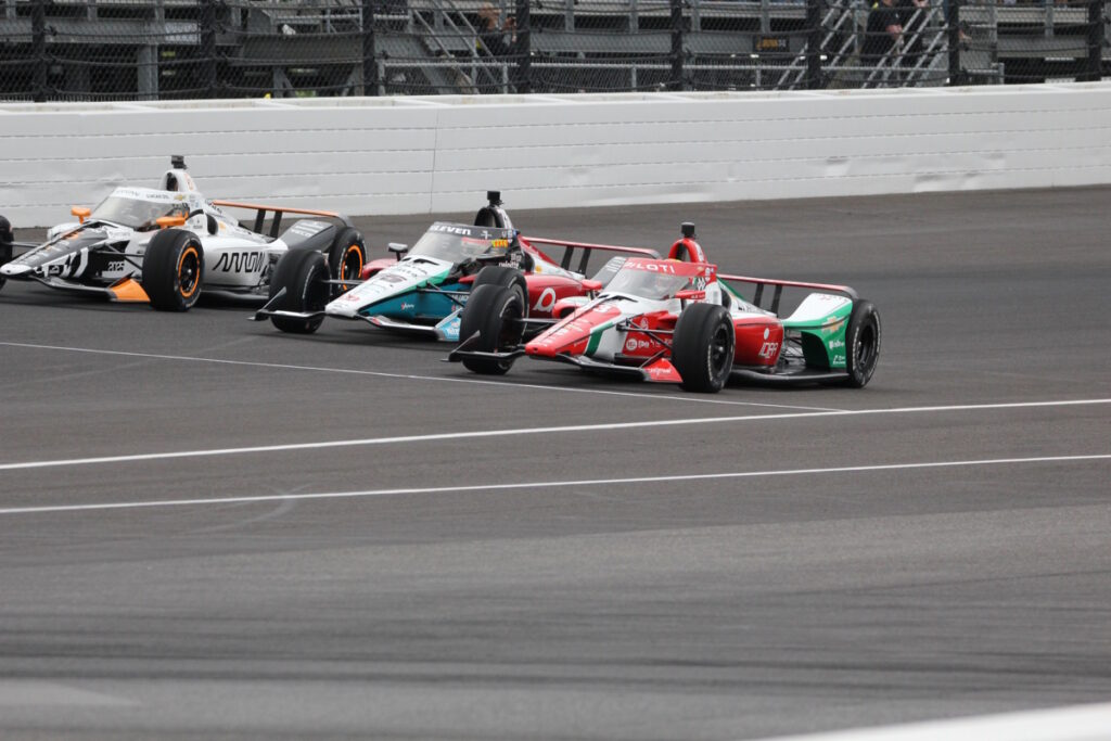 The 2025 Indianapolis 500 starting row exits Turn 4 on the pace lap. From top to bottom; #5 Pato O’Ward finished 3rd, #75 Takuma Sato finished 9th and Pole starter #83 Robert Shwartzman crashed into his pit crew on Lap 87 ending his day to finish in 26th place.