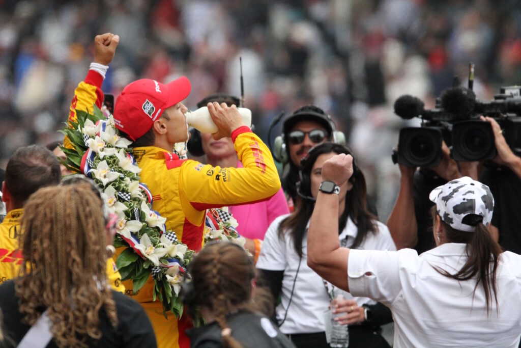 Indy 500 winner Alex Palou takes the traditional winner's podium drink of milk. All drivers are asked before the race what kind of milk they prefer, and Palou stayed with the tradition of whole milk.