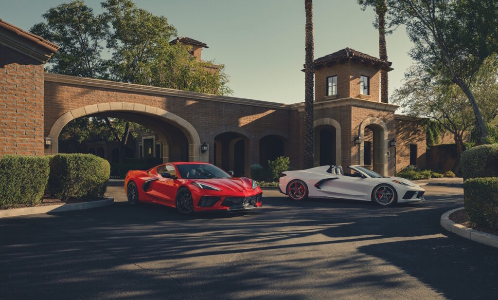 The 2027 Chevrolet Corvette Stingray in Torch Red and Arctic White positioned side by side.
