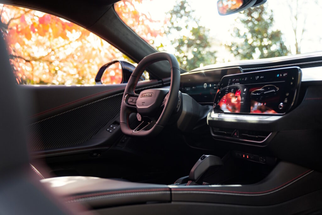 The new multi-energy Charger lineup includes the SIXPACK-powered 2026 Dodge Charger Scat Pack (right, shown in Peel Out exterior color) and the all-electric 2026 Dodge Charger Daytona Scat Pack (shown in White Knuckle).
