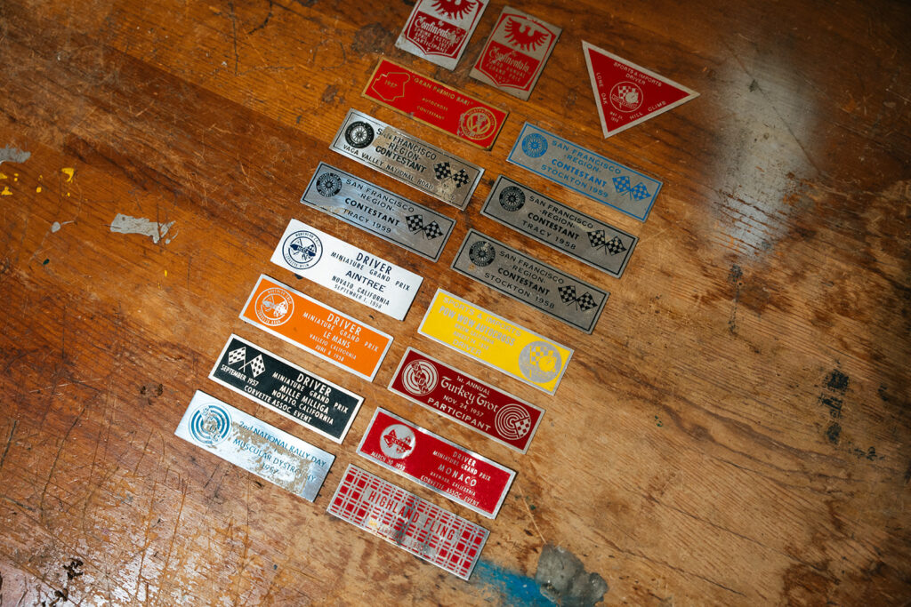 A collection of late-1950s racing and club event dash plaques, including SCCA San Francisco Region events, Cotati, Tracy, Stockton, Vaca Valley, and Miniature Grand Prix plaques from California’s grassroots sports car scene.