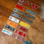 A collection of late-1950s racing and club event dash plaques, including SCCA San Francisco Region events, Cotati, Tracy, Stockton, Vaca Valley, and Miniature Grand Prix plaques from California’s grassroots sports car scene.