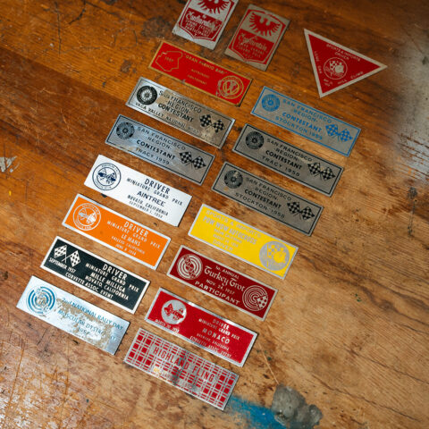 A collection of late-1950s racing and club event dash plaques, including SCCA San Francisco Region events, Cotati, Tracy, Stockton, Vaca Valley, and Miniature Grand Prix plaques from California’s grassroots sports car scene.