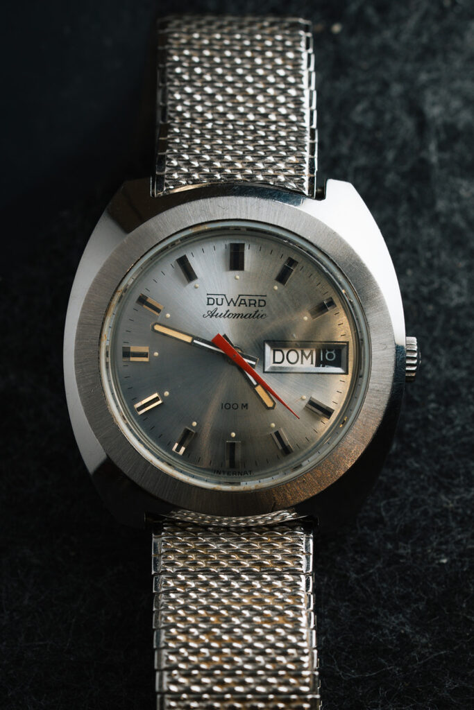 1970s Duward Automatic 100M Internat stainless steel watch with silver dial and Spanish day wheel