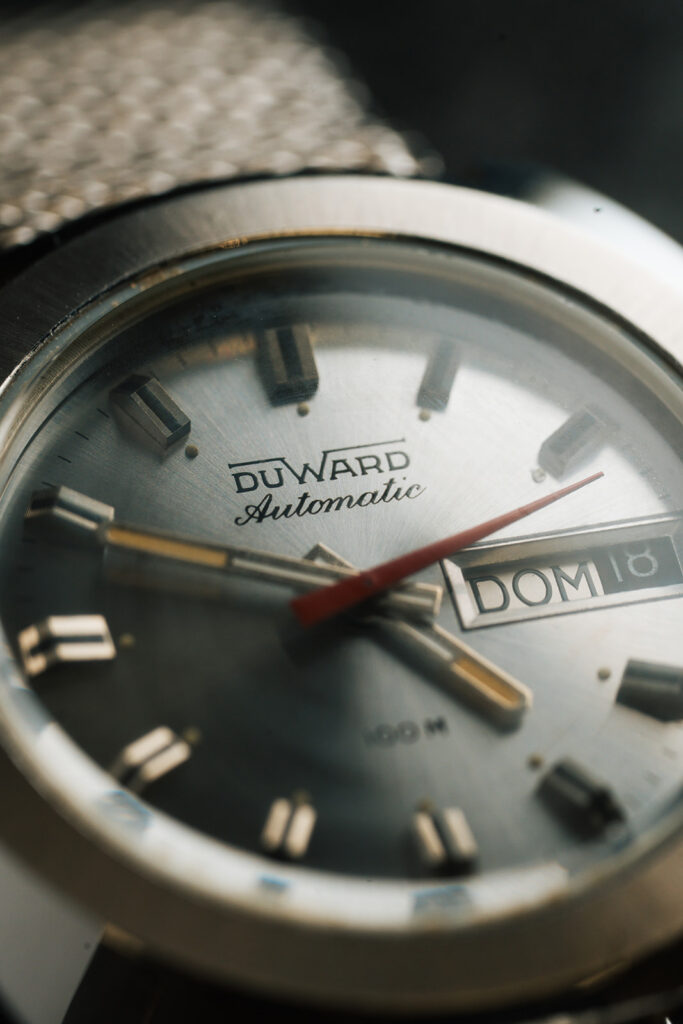 1970s Duward Automatic 100M Internat stainless steel watch with silver dial and Spanish day wheel