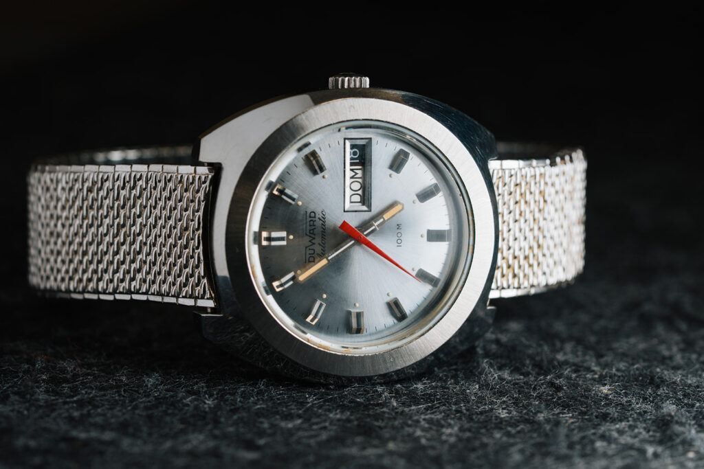 1970s Duward Automatic 100M Internat stainless steel watch with silver dial and Spanish day wheel